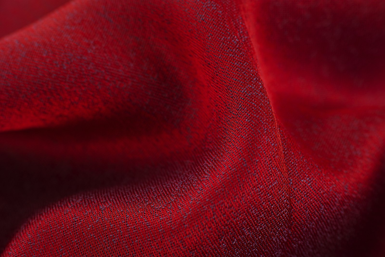 Close-up of red textile showing fabric fiber detail