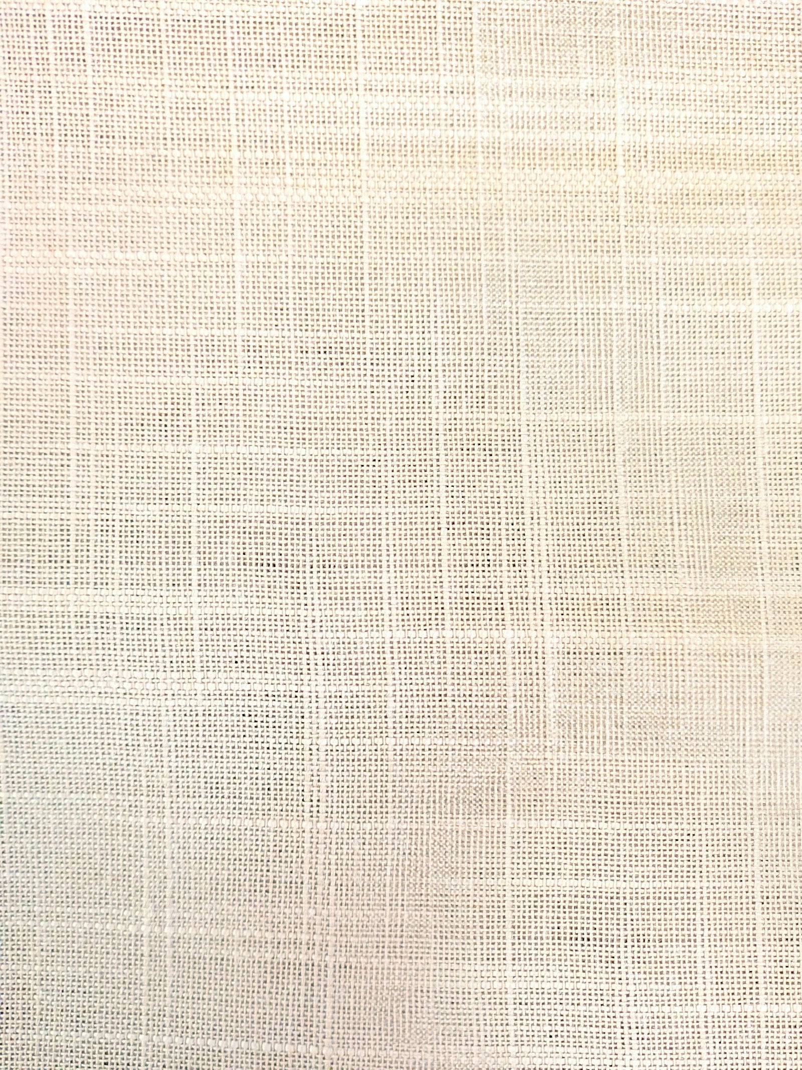 Close-up of beige woven fabric showing grid construction